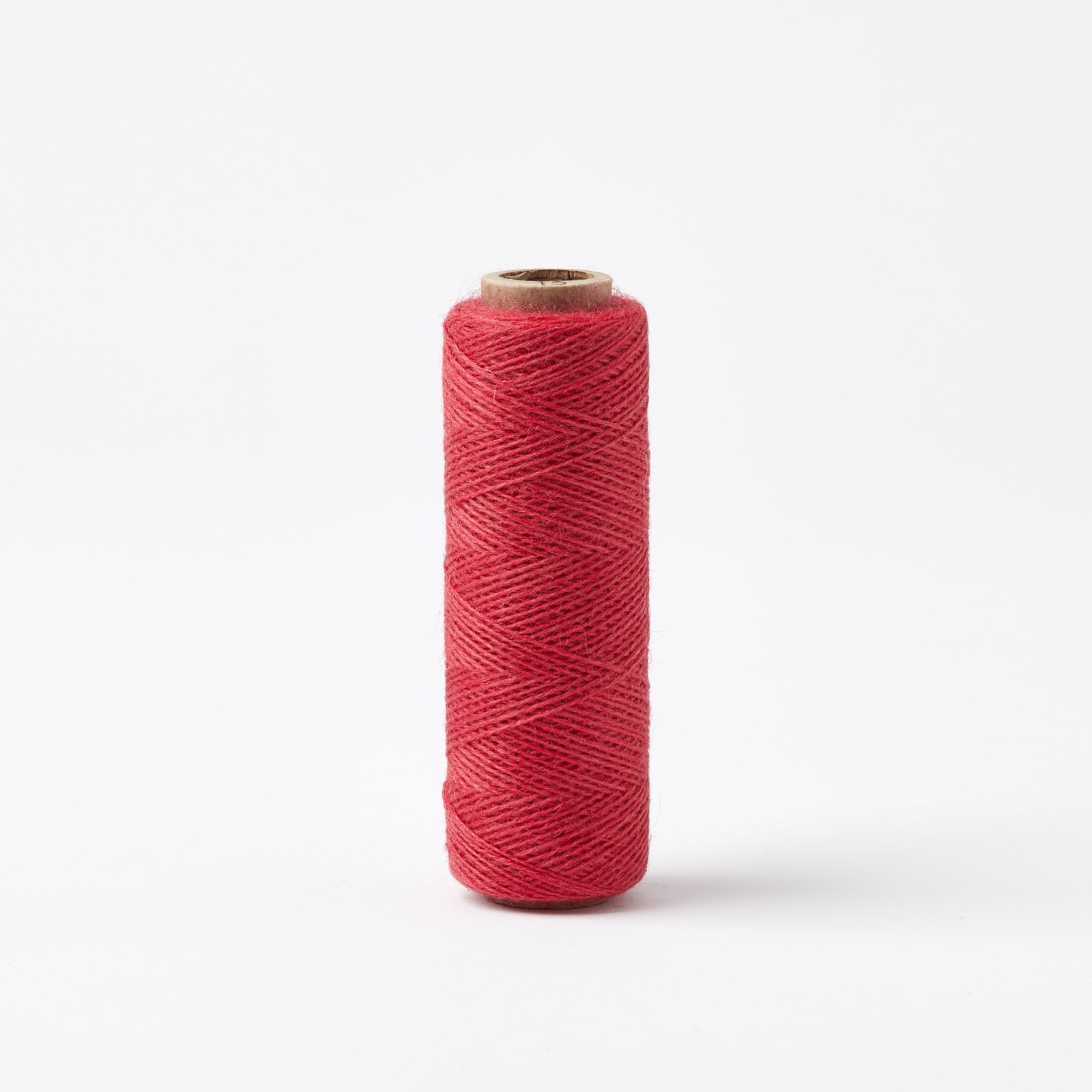 Array Wool Yarn ~ Cherry spool of thin, sturdy worsted spun yarn in vibrant cherry red on white background