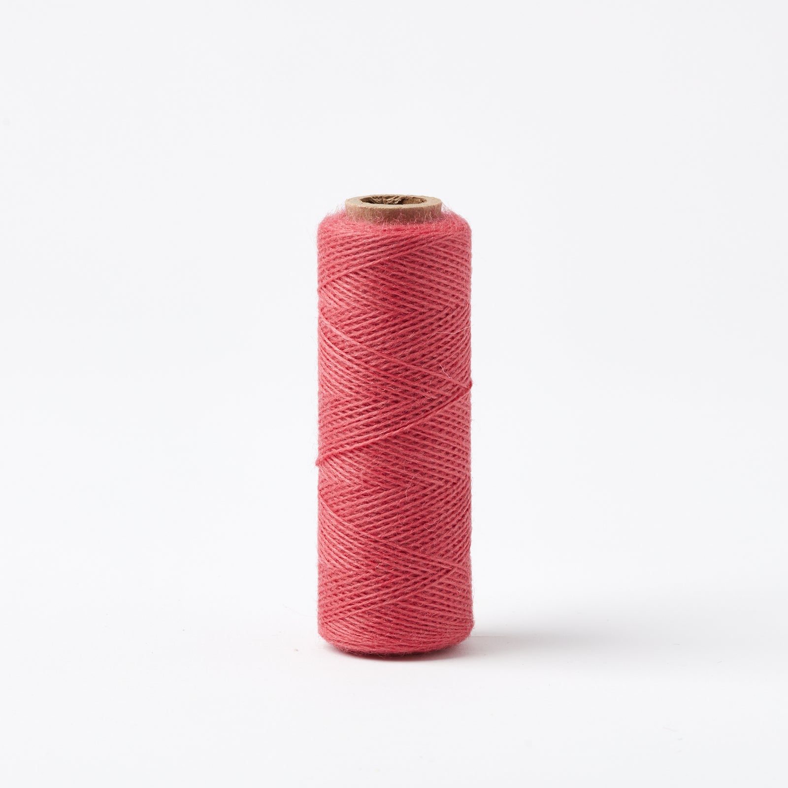 Array Wool Yarn ~ Cherry spool of thin, sturdy worsted spun yarn for home decor and garments isolated on white background