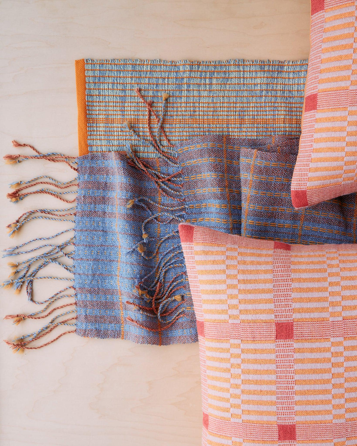 Chroma - Set of Three Patterns showing woven textiles and pillows in blue, orange, and pink geometric designs.