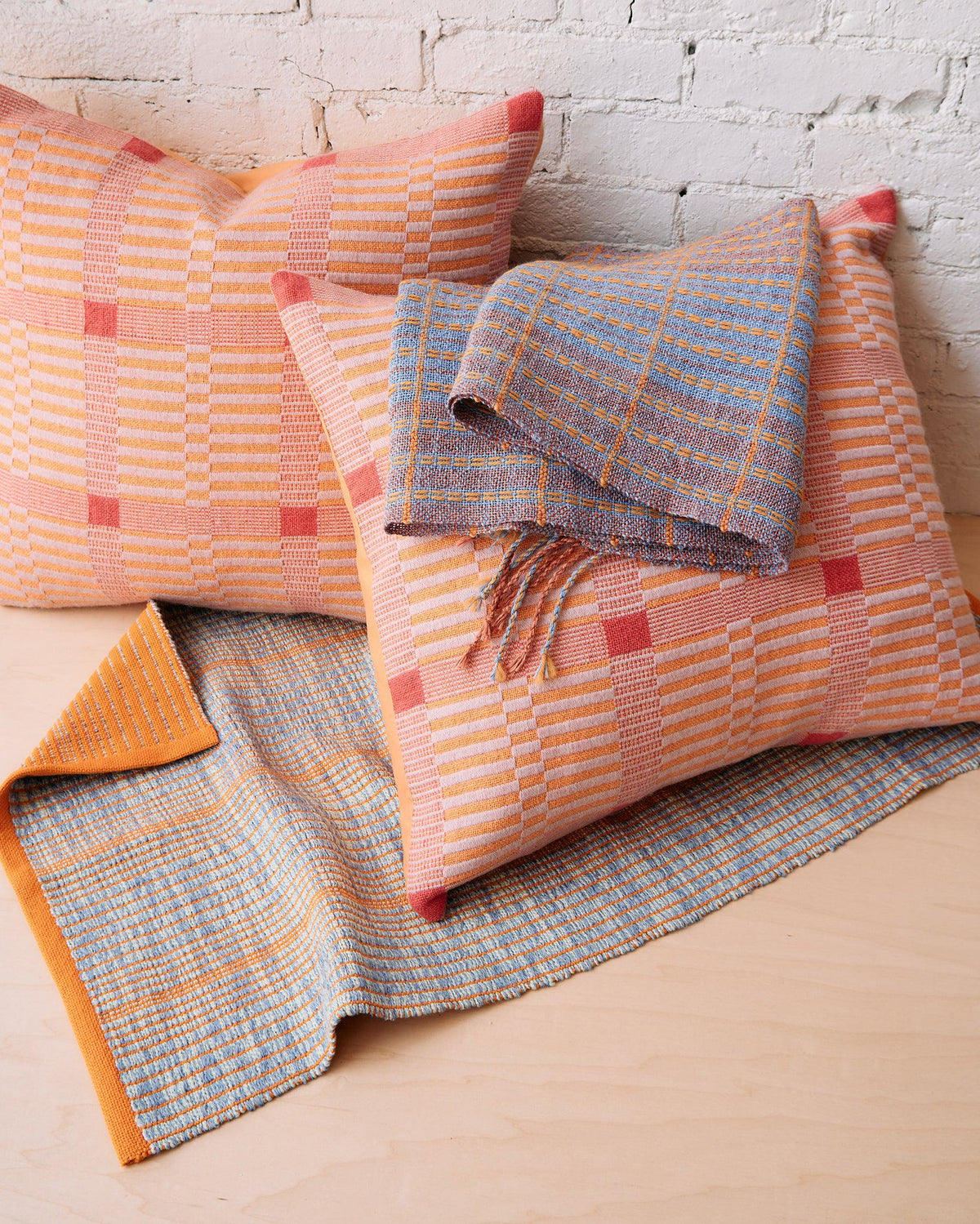 Chroma - Set of Three Patterns featuring woven pillows and scarves in warm and cool color blocked designs.