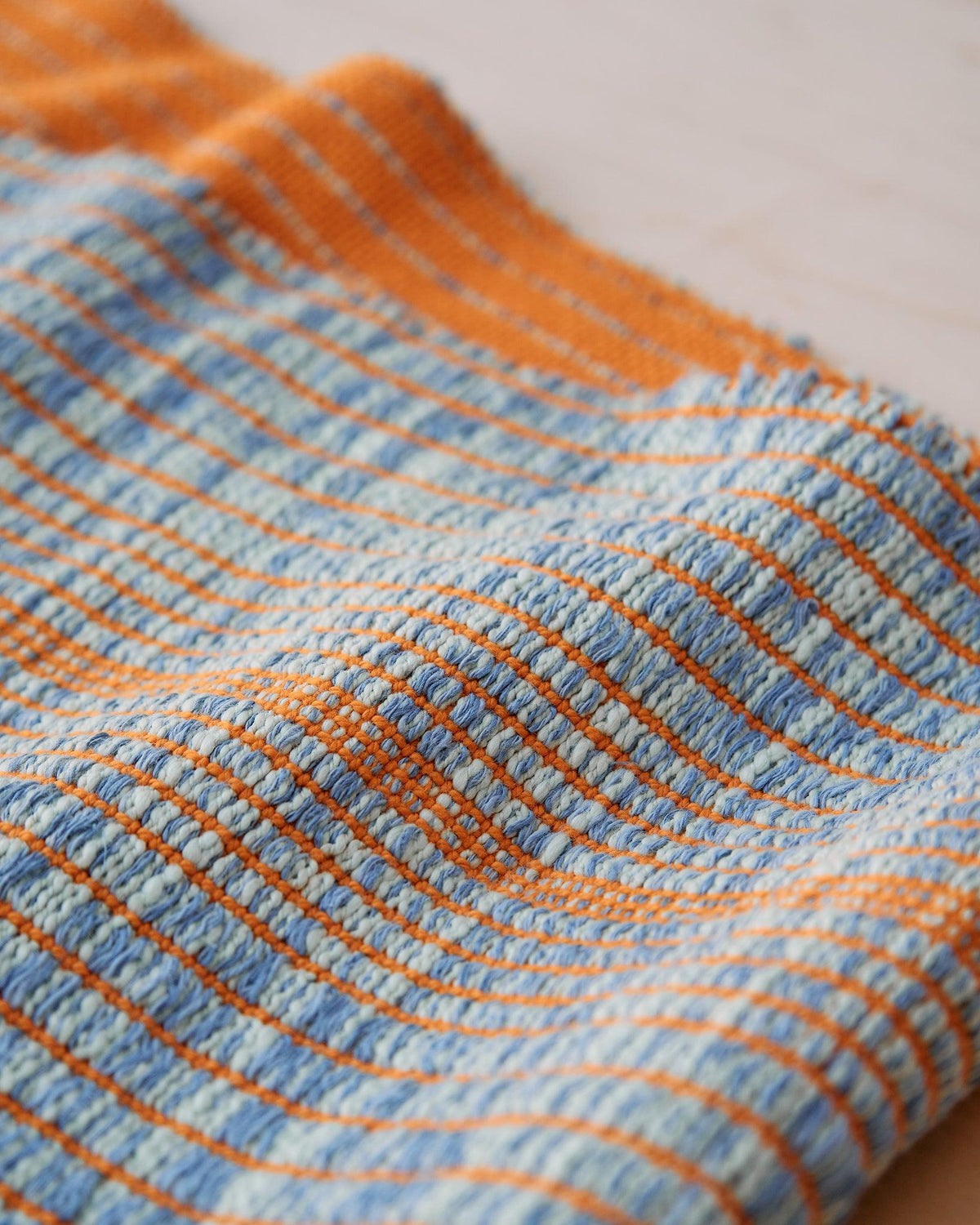 Chroma - Set of Three Patterns showing close-up of textured blue and orange woven fabric with striped design.