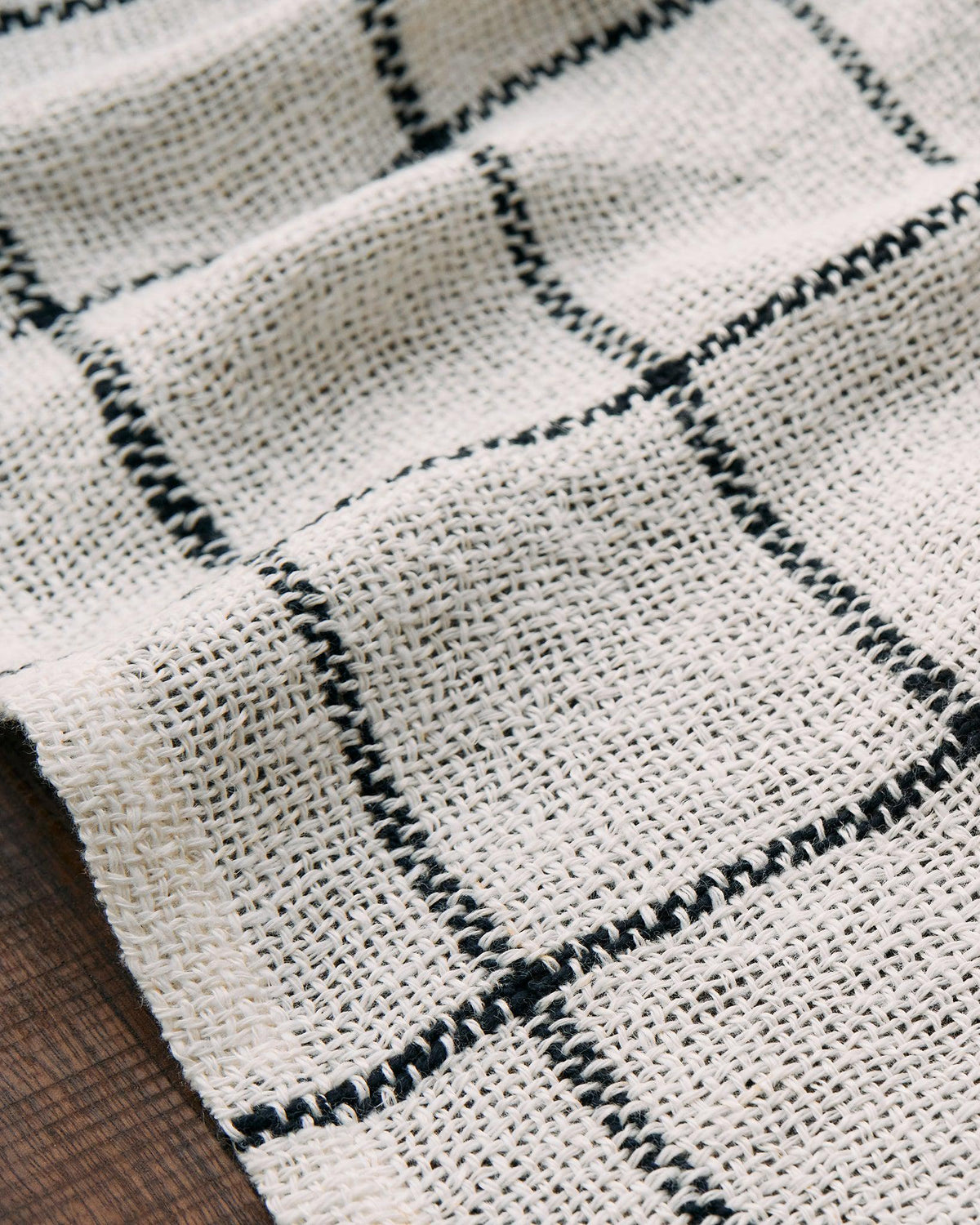 Close-up of handwoven minimalist fabric with black grid pattern in Forest Walk - Set of Three Patterns collection