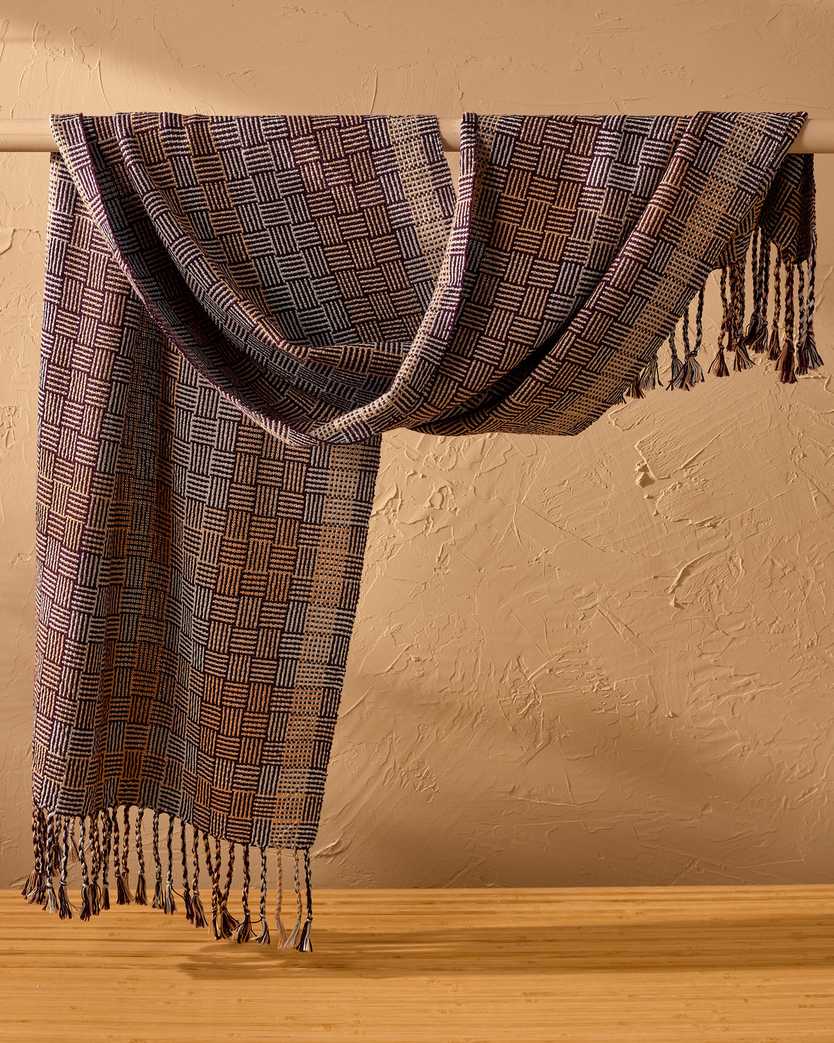 tri-tone shawl draped on a rail