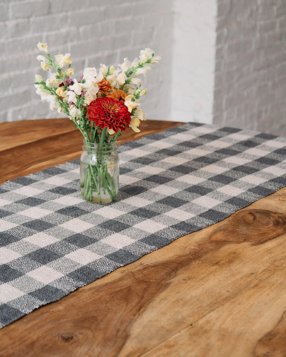 Forest Walk - Set of Three Patterns featuring a checkered runner on wooden table with glass jar of flowers.