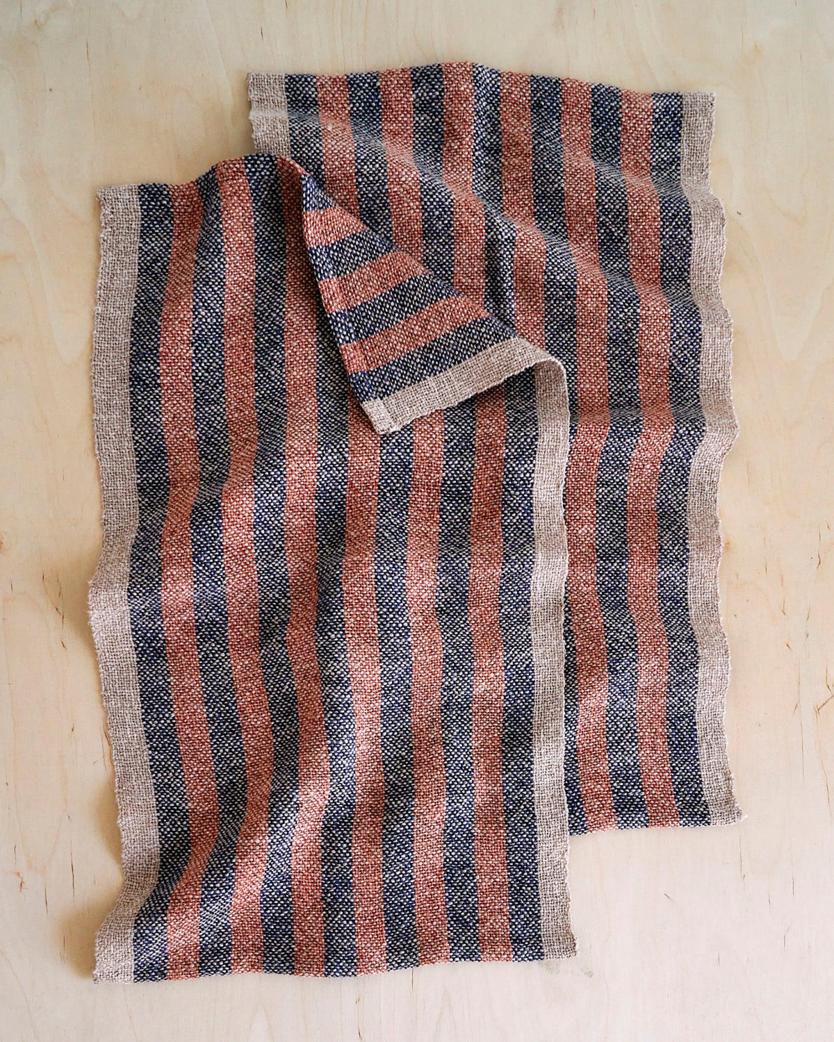 Duet Favorites - Set of Two Patterns striped woven textile in rust, dusk, and dune colors on wooden surface.